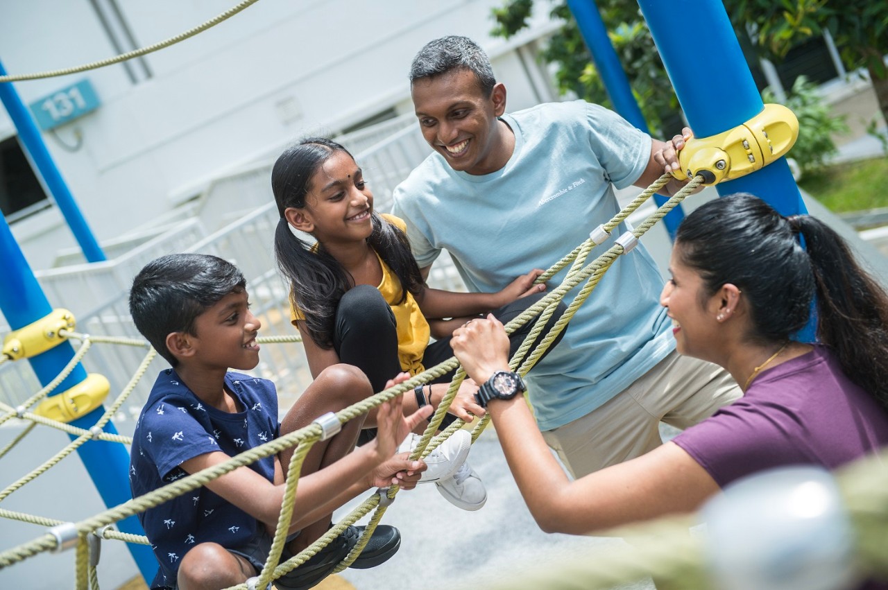 Parents enjoying a day out at the playground with their kids